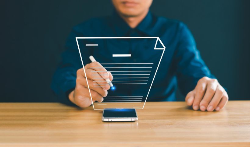 A businessman signs documents on a virtual screen.