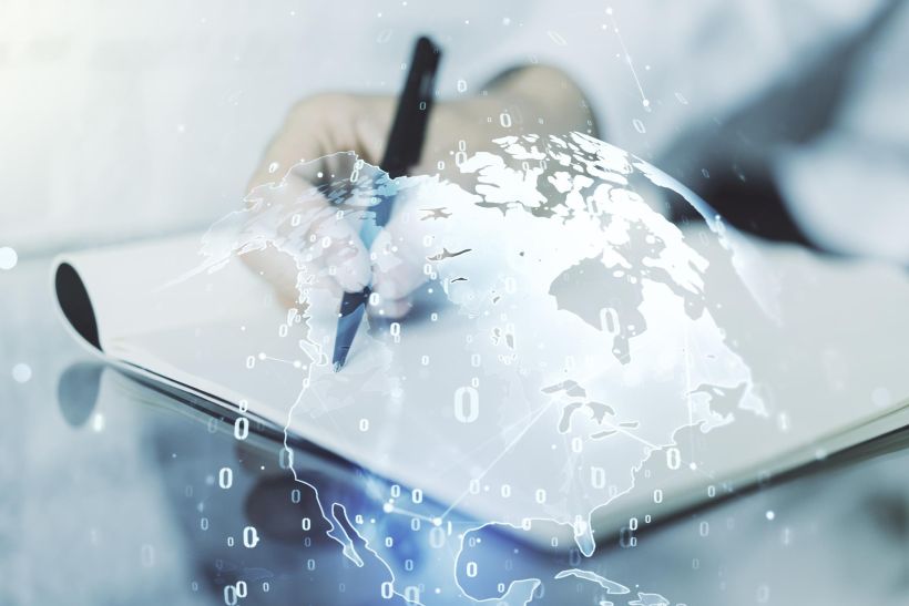 Multi exposure of abstract software development hologram with world map and man hand writing in notebook.