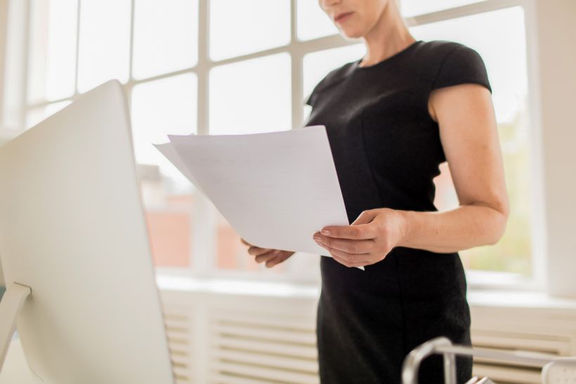 Smart woman holding financial documents.