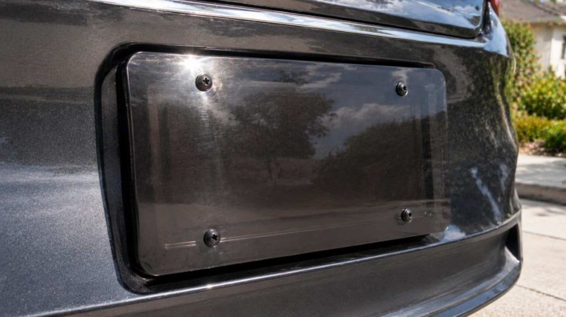 A dark tinted shield that violates California license plate frame cover laws